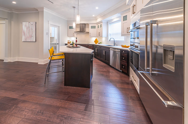 Seamless Flow Between Floor And Cabinetry Using A Dark Brown Color And A Creamy Wall