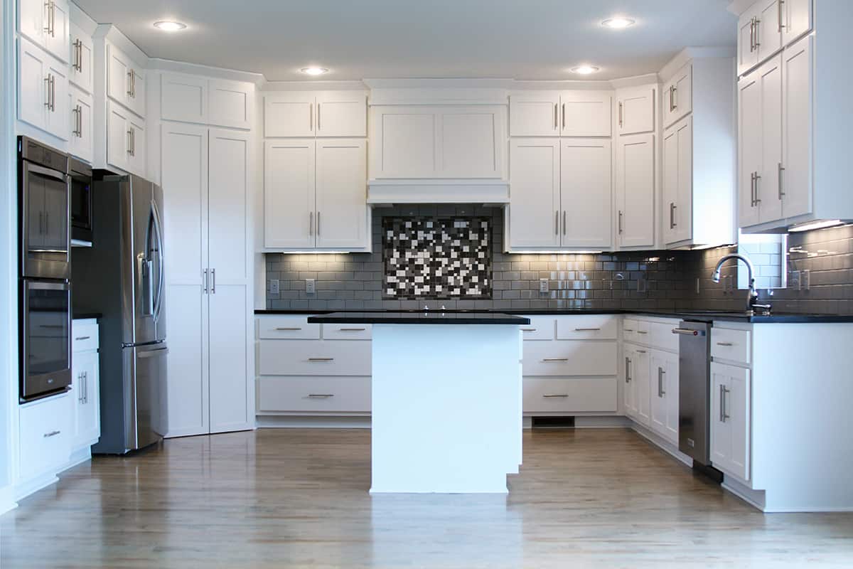 modern white kitchen cabinets with black countertops